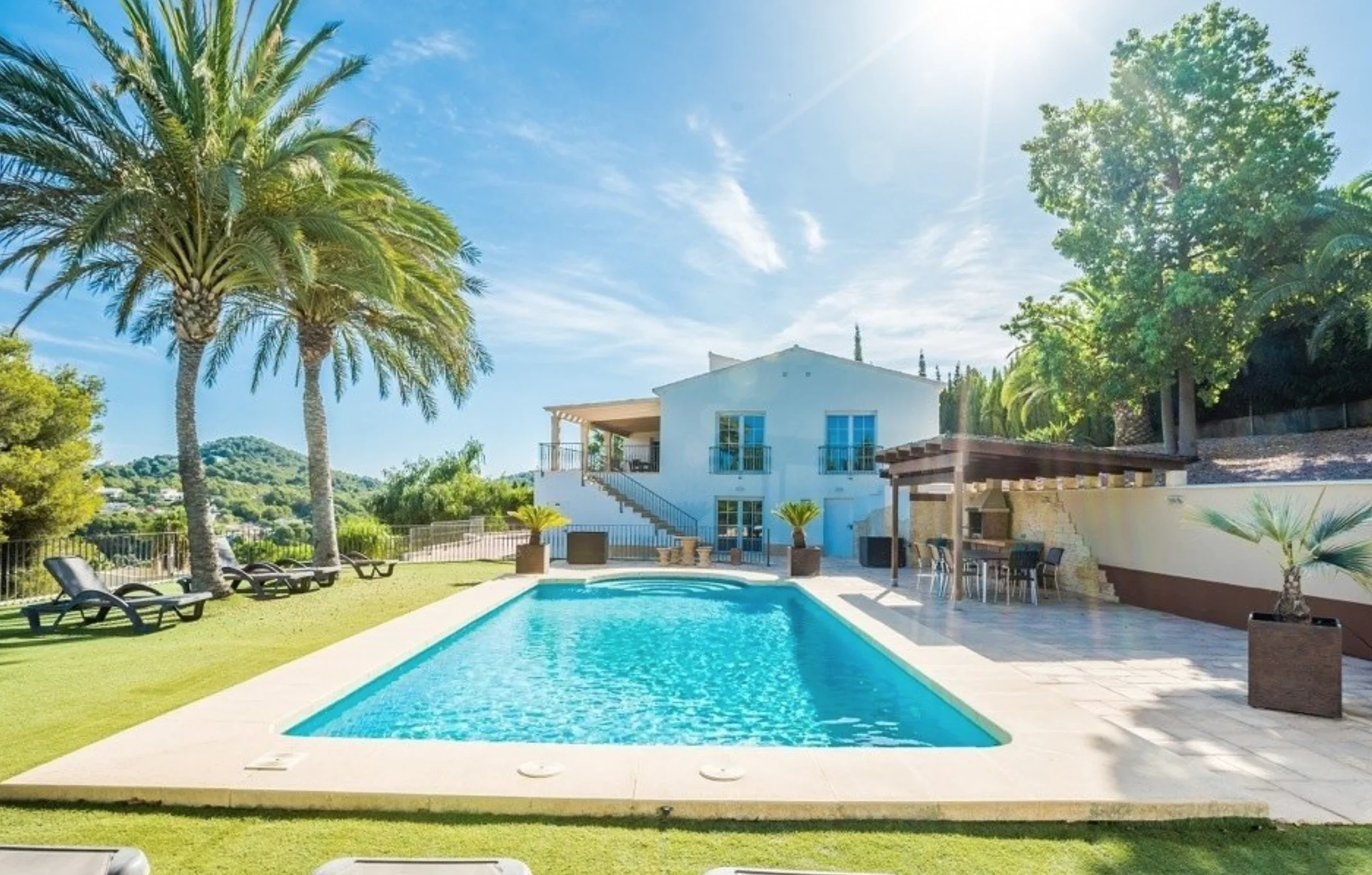 Piscina y fachada de esta villa en Jávea