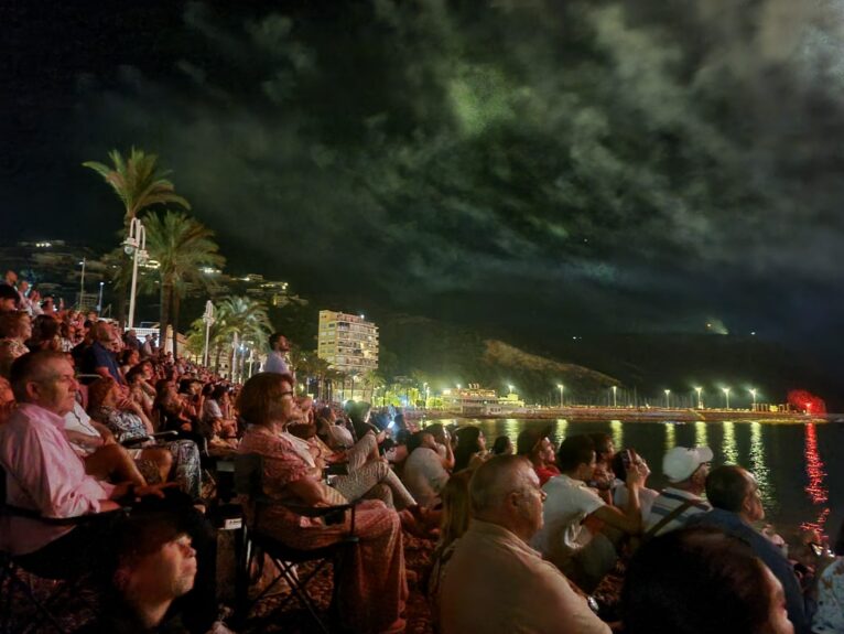 Público en la playa de la Grava observando el castillo de fuegos